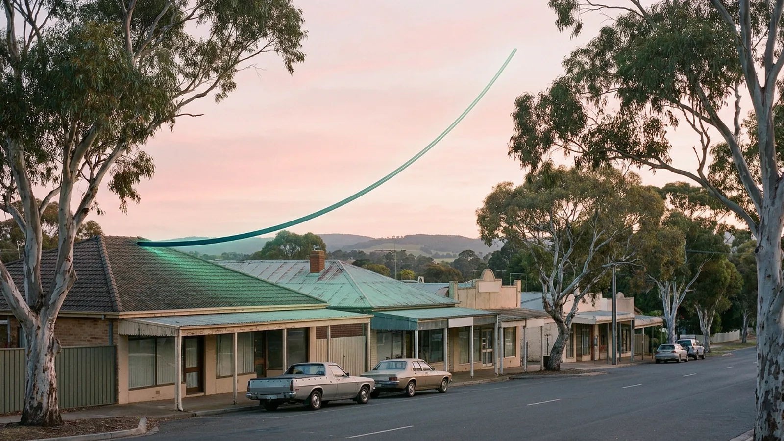 A quiet Australian coastal high street at dawn with a single glowing teal line curving upward above the rooftops